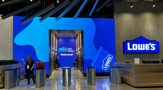 Lowe's building entryway with blue background welcoming people to the Into the Blue product pitch competition